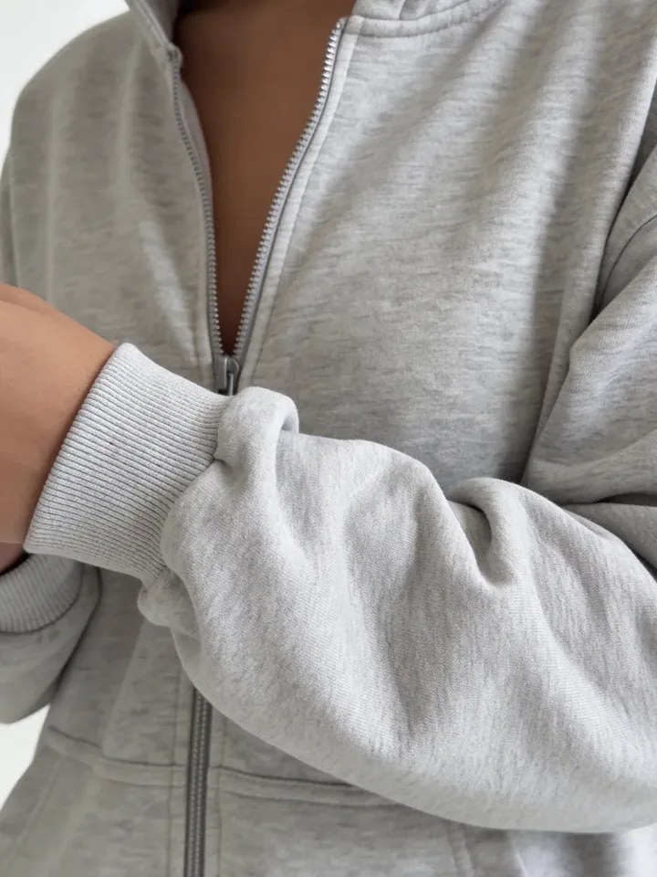 Close-up of the sleeve and texture of the grey NAZZANI hoodie