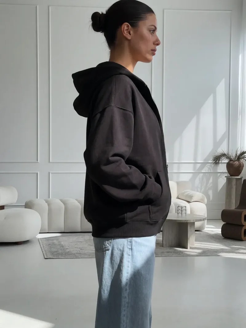 Side view of the black NAZZANI oversize zip hoodie fit