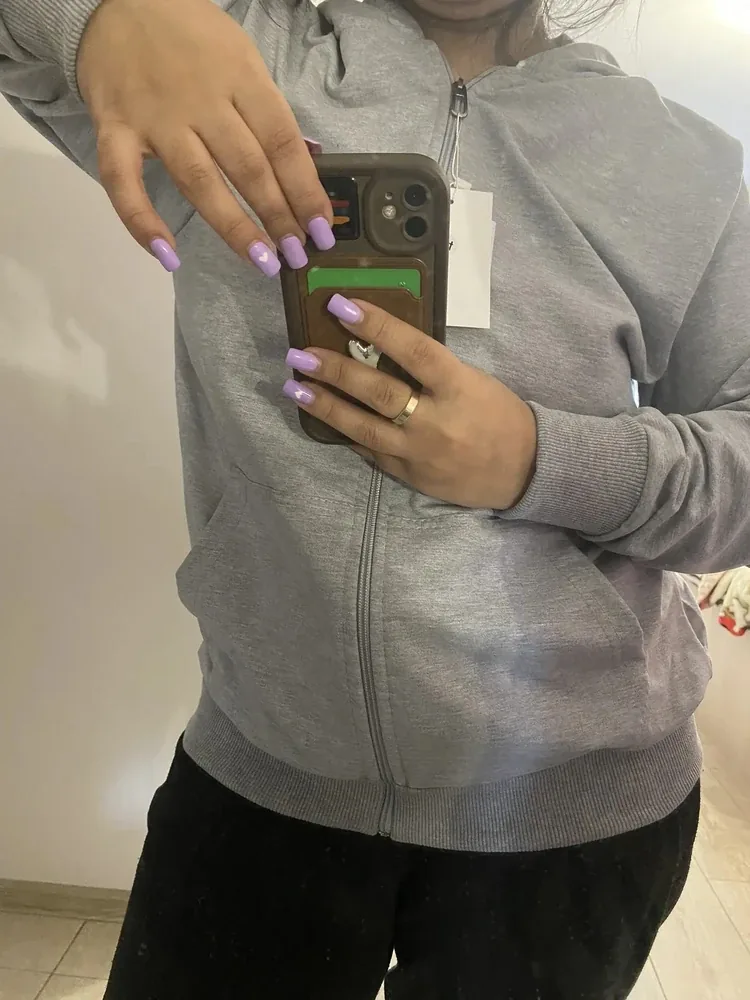 Customer wearing a grey NAZZANI zip hoodie